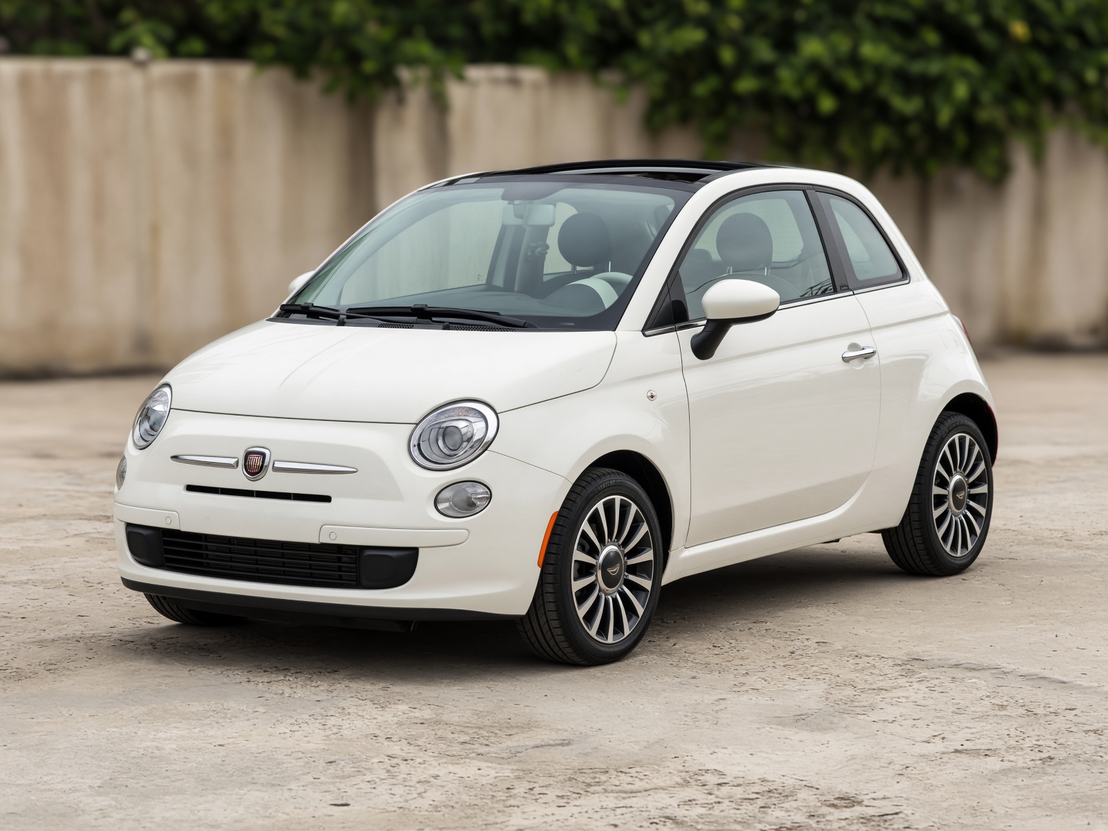 White Fiat 500 city car, three-quarter front view